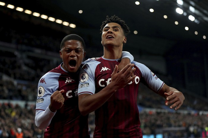 Aston Villa's Ollie Watkins celebrates scoring the opening goal with Leon Bailey during the Premier League match at Villa Park, Birmingham, Britain, Saturday Nov. 20, 2021.  (Bradley Collyer/PA via AP)