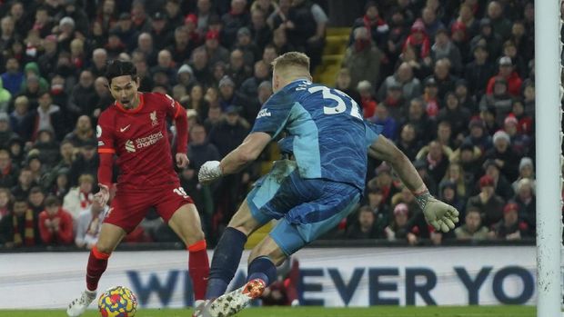Liverpool's Takumi Minamino scores his side's fourth goal during the English Premier League soccer match between Liverpool and Arsenal at Anfield Stadium, Liverpool, England, Saturday, Nov. 20, 2021. (AP Photo/Jon Super)