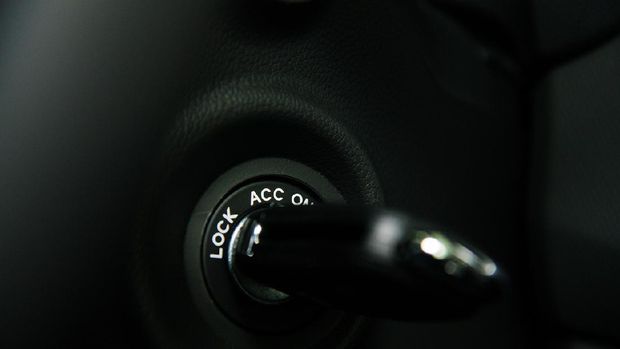 Car interior details close-up. Car key into ignition lock