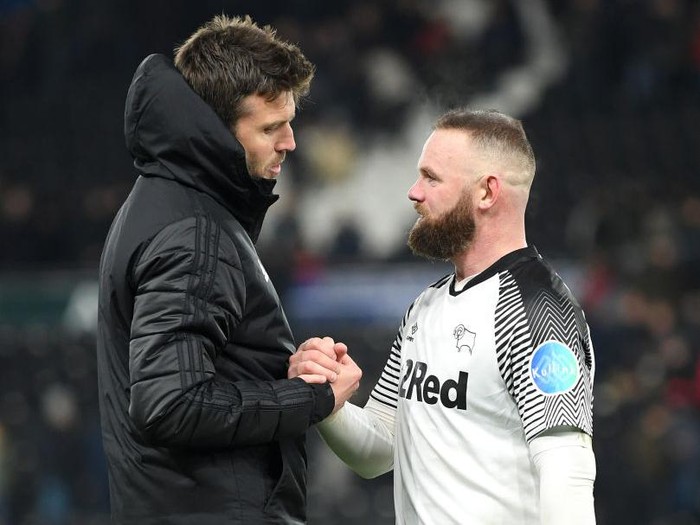 DERBY, ENGLAND - MARCH 05: Wayne Rooney of Derby County with Michael Carrick, coach of Manchester United during the FA Cup Fifth Round match between Derby County and Manchester United at Pride Park on March 05, 2020 in Derby, England. (Photo by Michael Regan/Getty Images)