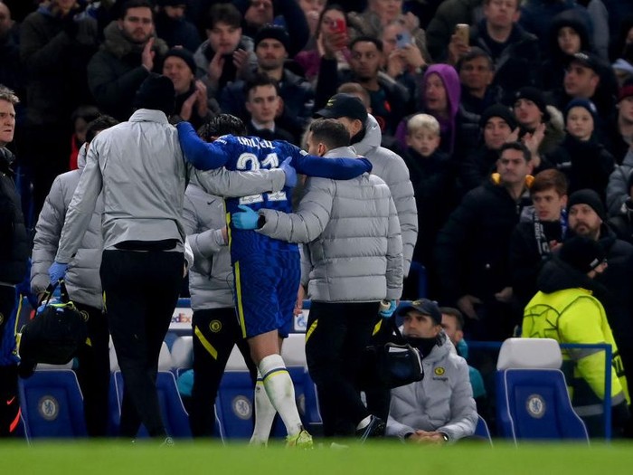 LONDON, ENGLAND - NOVEMBER 23: Ben Chilwell of Chelsea is helped off the pitch after receiving medical treatment during the UEFA Champions League group H match between Chelsea FC and Juventus at Stamford Bridge on November 23, 2021 in London, England. (Photo by Mike Hewitt/Getty Images)