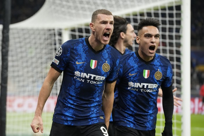 Inter Milans Edin Dzeko left, celebrates after scoring his sides first goal with his teammate Lautaro Martinez during the Champions League, Group D soccer match between Inter Milan and Shakhtar Donetsk at the San Siro stadium in Milan, Italy, Wednesday, Nov. 24, 2021. (AP Photo/Luca Bruno)