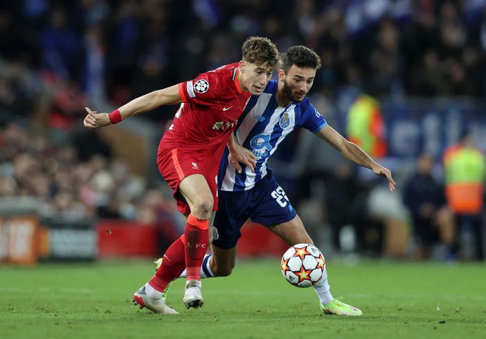 LIVERPOOL, ENGLAND - NOVEMBER 24: Kostas Tsimikas of Liverpool battles for possession with Joao Mario of FC Porto during the UEFA Champions League group B match between Liverpool FC and FC Porto at Anfield on November 24, 2021 in Liverpool, England. (Photo by Clive Brunskill/Getty Images)