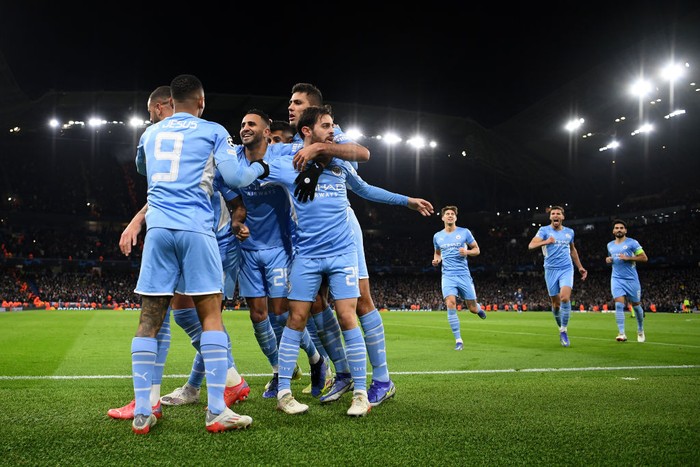 MANCHESTER, ENGLAND - NOVEMBER 24: Raheem Sterling of Manchester City (not pictured) celebrates with teammates Gabriel Jesus, Riyad Mahrez, Rodrigo and Bernardo Silva after scoring their teams first goal during the UEFA Champions League group A match between Manchester City and Paris Saint-Germain at Etihad Stadium on November 24, 2021 in Manchester, England. (Photo by Shaun Botterill/Getty Images)