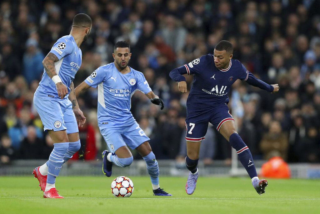 PSG's Kylian Mbappe, right, competes for the ball with Manchester City's Riyad Mahrez, center, and Manchester City's Kyle Walker during the Champions League group A soccer match between Manchester City and Paris Saint-Germain at the Etihad Stadium in Manchester, England, Wednesday, Nov. 24, 2021. (AP Photo/Scott Heppell)