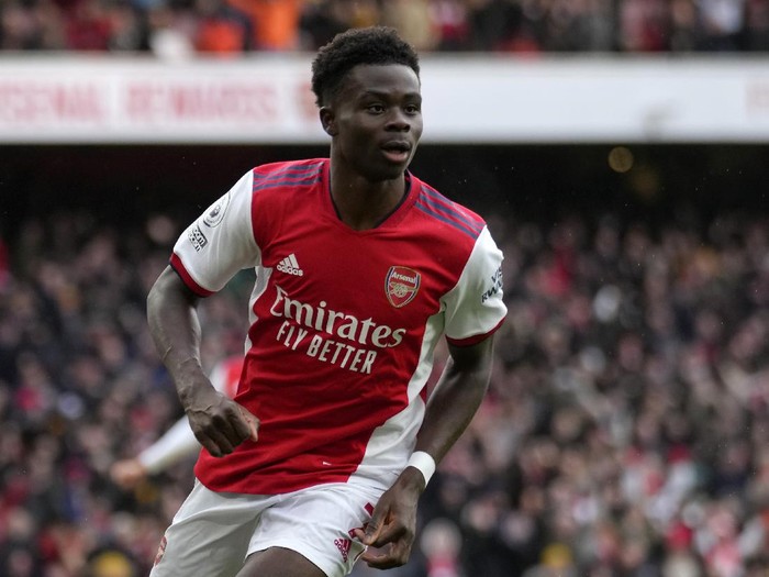 Arsenal's Bukayo Saka celebrates after scoring his side's opening goal during the English Premier League soccer match between Arsenal and Newcastle United at Emirates stadium in London, Saturday, Nov. 27, 2021. (AP Photo/Kirsty Wigglesworth)