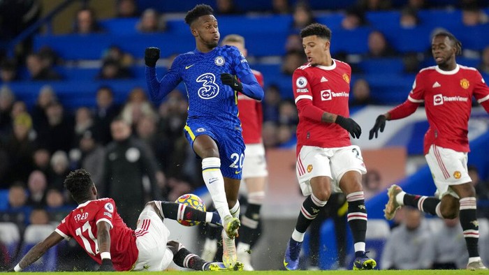 Manchester Uniteds Fred, left, tackles Chelseas Callum Hudson-Odoi during the English Premier League soccer match between Chelsea and Manchester United at Stamford Bridge stadium in London, Sunday, Nov. 28, 2021. (AP Photo/Kirsty Wigglesworth)
