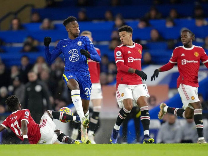 Manchester Uniteds Fred, left, tackles Chelseas Callum Hudson-Odoi during the English Premier League soccer match between Chelsea and Manchester United at Stamford Bridge stadium in London, Sunday, Nov. 28, 2021. (AP Photo/Kirsty Wigglesworth)