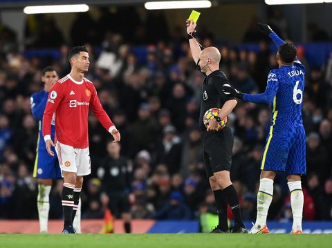 LONDON, ENGLAND - NOVEMBER 28: Match Referee, Anthony Taylor shows a yellow card to Cristiano Ronaldo of Manchester United during the Premier League match between Chelsea and Manchester United at Stamford Bridge on November 28, 2021 in London, England. (Photo by Shaun Botterill/Getty Images )