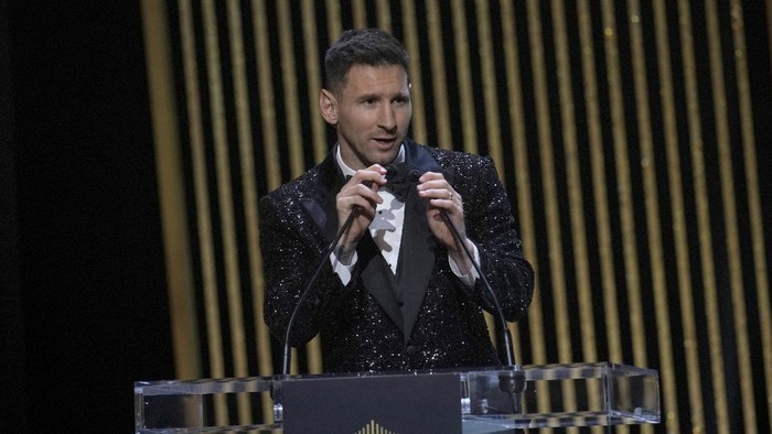 PSG player Lionel Messi reacts after winning the 2021 Ballon dOr trophy during the 65th Ballon dOr ceremony at Theatre du Chatelet, in Paris, Monday, Nov. 29, 2021. (AP Photo/Christophe Ena)