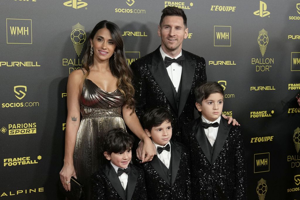 PSG player Lionel Messi, his wife Antonela Roccuzzo and their sons Thiago, Matteo and Ciro arrive for the 65th Ballon d'Or ceremony at Theatre du Chatelet, in Paris, Monday, Nov. 29, 2021. (AP Photo/Christophe Ena)