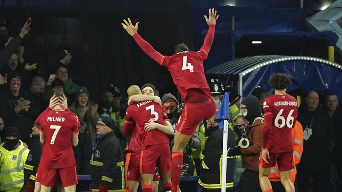 Liverpool players celebrate after teammate Liverpools Diogo Jota scored their sides fourth goal during the English Premier League soccer match between Everton and Liverpool at Goodison Park in Liverpool, England, Wednesday, Dec. 1, 2021. (AP Photo/Jon Super)