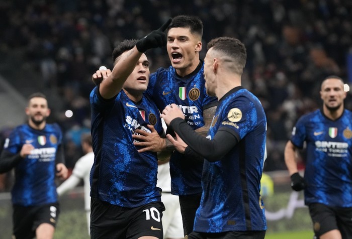 Inter Milans Lautaro Martinez, left, celebrates with his teammates Joaquin Correa, center, and Ivan Perisic after scoring his sides second goal during the Serie A soccer match between Inter Milan and Spezia at the San Siro Stadium, in Milan, Italy, Wednesday, Dec. 1, 2021. (AP Photo/Luca Bruno)