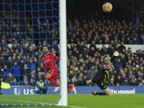 Liverpool's Mohamed Salah, left, scores past Everton's goalkeeper Jordan Pickford his side's second goal during the English Premier League soccer match between Everton and Liverpool at Goodison Park in Liverpool, England, Wednesday, Dec. 1, 2021. (AP Photo/Jon Super)