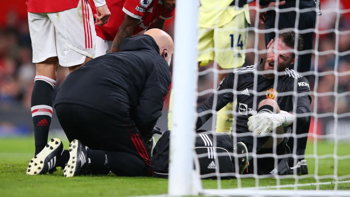 David De Gea tersungkur setelah kakinya diinjak rekan sendiri. (Foto: Getty Images/Alex Livesey)