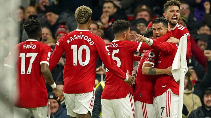 Manchester Uniteds Cristiano Ronaldo, second right, celebrates after scoring his sides second goal during the English Premier League soccer match between Manchester United and Arsenal at Old Trafford stadium in Manchester, England, Thursday, Dec. 2, 2021. (AP Photo/Dave Thompson)