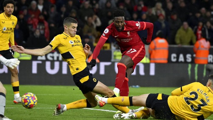 Liverpool's Divock Origi, center, scores the opening goal during the English Premier League soccer match between Wolverhampton Wanderers and Liverpool at the Molineux Stadium in Wolverhampton, England, Saturday, Dec. 4, 2021. (AP Photo/Rui Vieira)