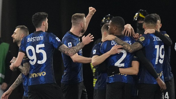 Inter Milan players celebrate after their teammate Hakan Calhanoglu scored their sides first goal during a Serie A soccer match between Roma and Inter Milan, at Romes Olympic Stadium, Saturday, Dec. 4, 2021. (AP Photo/Andrew Medichini)