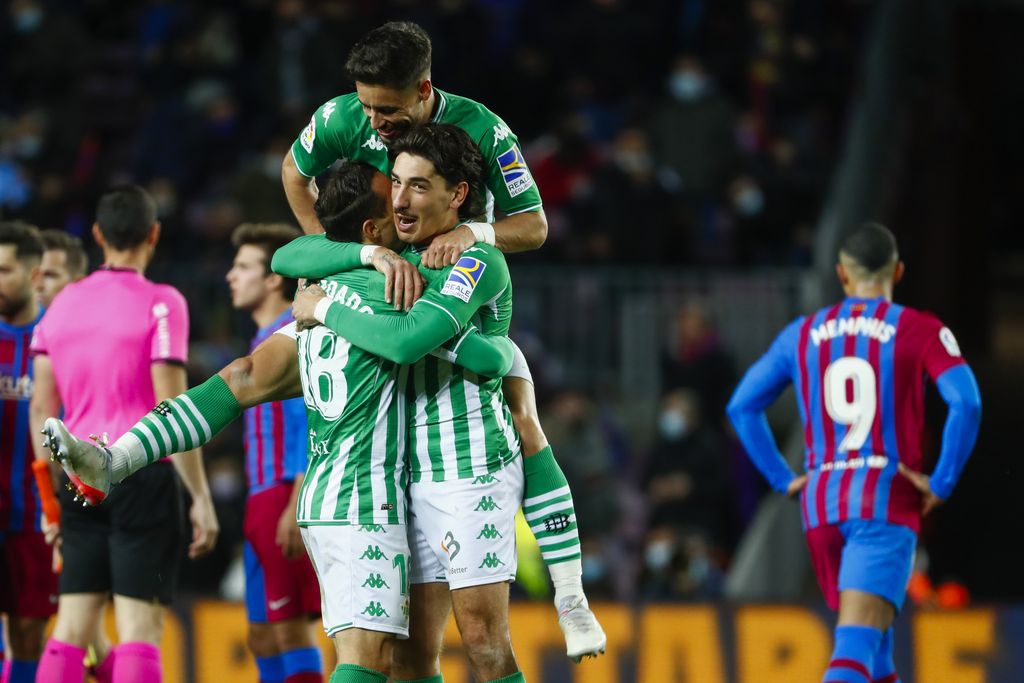 Betis players celebrate at the end of the Spanish La Liga soccer match between Barcelona and Real Betis at the Camp Nou stadium, in Barcelona, Spain, Saturday, Dec. 4, 2021. Betis won 1-0. (AP Photo/Joan Monfort)