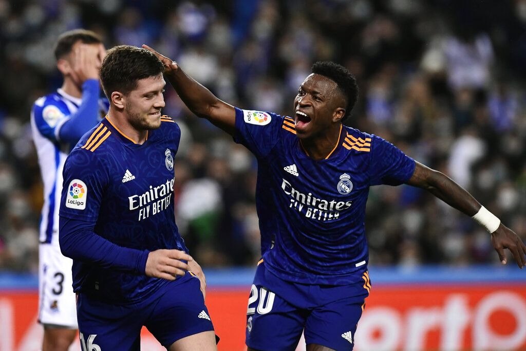 Real Madrid's Luka Jovic celebrates with Vinicius Junior, right, after scoring their side's second goal during the Spanish La Liga soccer match between Real Sociedad and Real Madrid at Reale Arena stadium in San Sebastian, Spain, Saturday, Dec. 4, 2021. (AP Photo/Alvaro Barrientos)