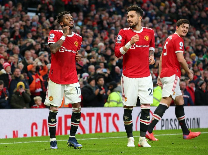 MANCHESTER, ENGLAND - DECEMBER 05: Fred of Manchester United celebrates with Alex Telles after scoring their sides first goal during the Premier League match between Manchester United and Crystal Palace at Old Trafford on December 05, 2021 in Manchester, England. (Photo by Alex Livesey/Getty Images)