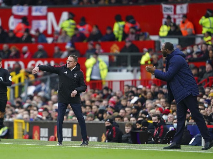 Crystal Palace's head coach Patrick Vieira, right, and Manchester United's manager Ralf Rangnick, centre, react during the English Premier League soccer match between Manchester United and Crystal Palace at Old Trafford stadium in Manchester, England, Sunday, Dec. 5, 2021. (AP Photo/Jon Super)