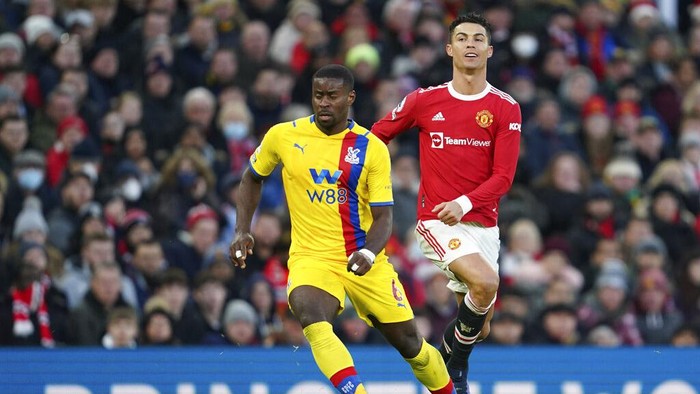 Manchester United's Cristiano Ronaldo, right, challenges for the ball with Crystal Palace's Marc Guehi during the English Premier League soccer match between Manchester United and Crystal Palace at Old Trafford stadium in Manchester, England, Sunday, Dec. 5, 2021. (AP Photo/Jon Super)