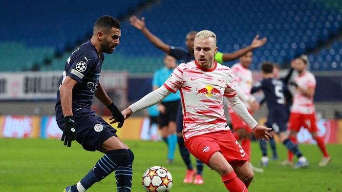 LEIPZIG, GERMANY - DECEMBER 07: Riyad Mahrez of Manchester City battles for possession with Angelino of RB Leipzig during the UEFA Champions League group A match between RB Leipzig and Manchester City at Red Bull Arena on December 07, 2021 in Leipzig, Germany. (Photo by Maja Hitij/Getty Images)