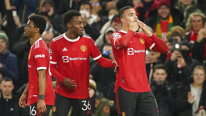 Manchester Uniteds Mason Greenwood, right, celebrates after scoring the opening goal during the Champions League group F soccer match between Manchester United and Young Boys, at Old Trafford stadium in Manchester, England, Wednesday, Dec. 8, 2021. (AP Photo/Dave Thompson)