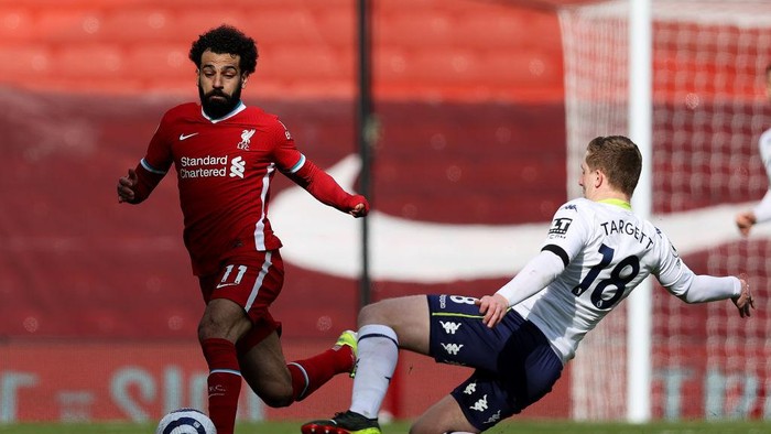 LIVERPOOL, ENGLAND - APRIL 10: Aston Villas Matt Targett vies with Liverpools Mohamed Salah during the Premier League match between Liverpool and Aston Villa at Anfield on April 10, 2021 in Liverpool, England. Sporting stadiums around the UK remain under strict restrictions due to the Coronavirus Pandemic as Government social distancing laws prohibit fans inside venues resulting in games being played behind closed doors. (Photo by Clive Brunskill/Getty Images)