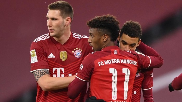 MUNICH, GERMANY - DECEMBER 11: Jamal Musiala  celebrates scoring his teams second goal with Niklas Süle and Kingsley Coman of Muenchen during the Bundesliga match between FC Bayern München and 1. FSV Mainz 05 at Allianz Arena on December 11, 2021 in Munich, Germany. (Photo by Sebastian Widmann/Getty Images)