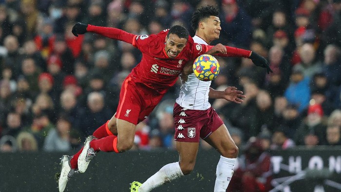 LIVERPOOL, ENGLAND - DECEMBER 11: Joel Matip of Liverpool battles for possession with Ollie Watkins of Aston Villa during the Premier League match between Liverpool and Aston Villa at Anfield on December 11, 2021 in Liverpool, England. (Photo by Clive Brunskill/Getty Images)