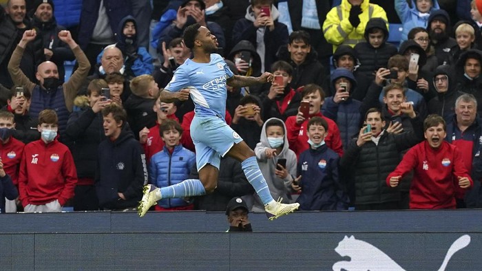 Manchester Citys Raheem Sterling celebrates after scoring his sides first goal on a penalty kick during the English Premier League soccer match between Manchester City and Wolverhampton Wanderers, at the Etihad stadium in Manchester, England, Saturday, Dec.11, 2021(Martin Rickett/PA via AP)