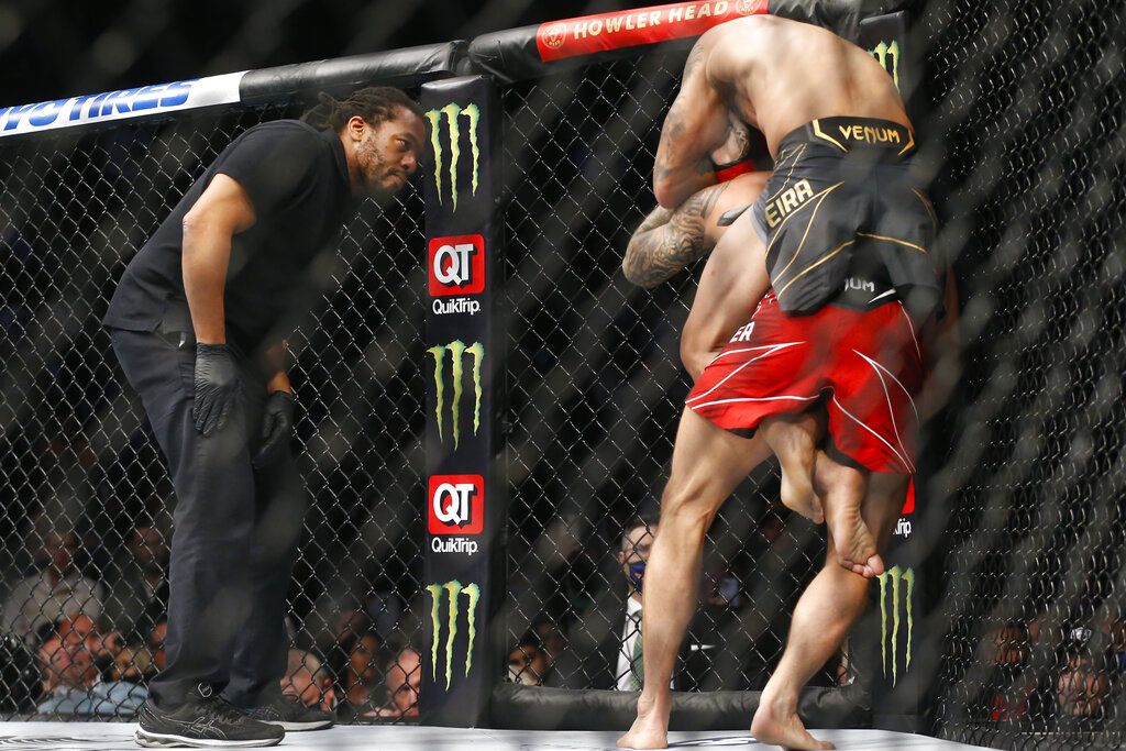 Charles Oliveira celebrates after defeating Dustin Poirier by submission in a lightweight mixed martial arts title bout at UFC 269, Saturday, Dec. 11, 2021, in Las Vegas. (AP Photo/Chase Stevens)