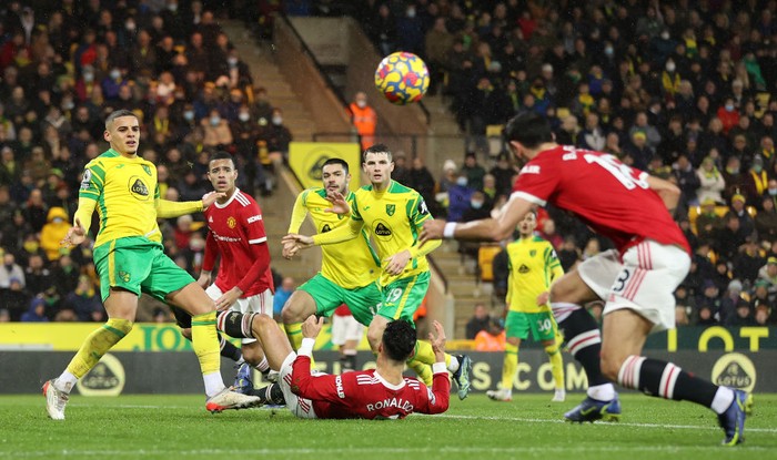 NORWICH, ENGLAND - DECEMBER 11: Cristiano Ronaldo of Manchester United is fouled by Max Aarons of Norwich City leading to a penalty being awarded to Manchester United during the Premier League match between Norwich City and Manchester United at Carrow Road on December 11, 2021 in Norwich, England. (Photo by Alex Pantling/Getty Images)