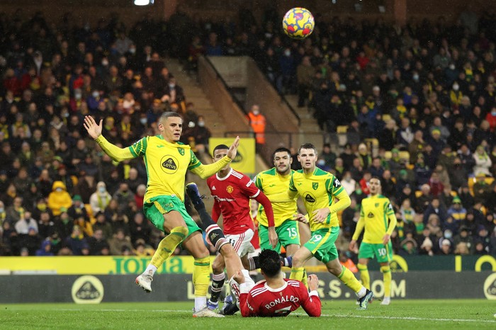 NORWICH, ENGLAND - DECEMBER 11: Cristiano Ronaldo of Manchester United is fouled by Max Aarons of Norwich City leading to a penalty being awarded to Manchester United during the Premier League match between Norwich City and Manchester United at Carrow Road on December 11, 2021 in Norwich, England. (Photo by Alex Pantling/Getty Images)