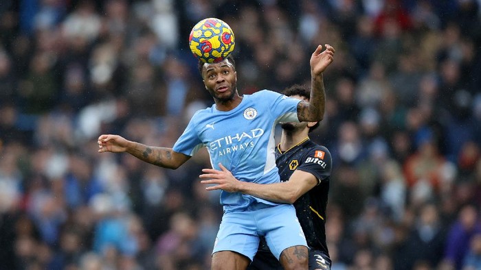 MANCHESTER, ENGLAND - DECEMBER 11: Raheem Sterling of Manchester City battles for possession with Rayan Ait-Nouri of Wolverhampton Wanderers during the Premier League match between Manchester City and Wolverhampton Wanderers at Etihad Stadium on December 11, 2021 in Manchester, England. (Photo by Naomi Baker/Getty Images)