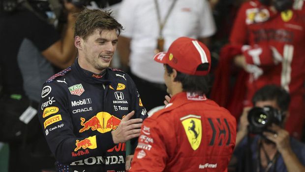 Red Bull driver Max Verstappen of the Netherlands, left, greets Spain's Carlos Sainz Jr. of Ferrari as he celebrates after becoming F1 drivers world champion after winning the Formula One Abu Dhabi Grand Prix in Abu Dhabi, United Arab Emirates, Sunday, Dec. 12. 2021. (AP Photo/Kamran Jebreili, Pool)