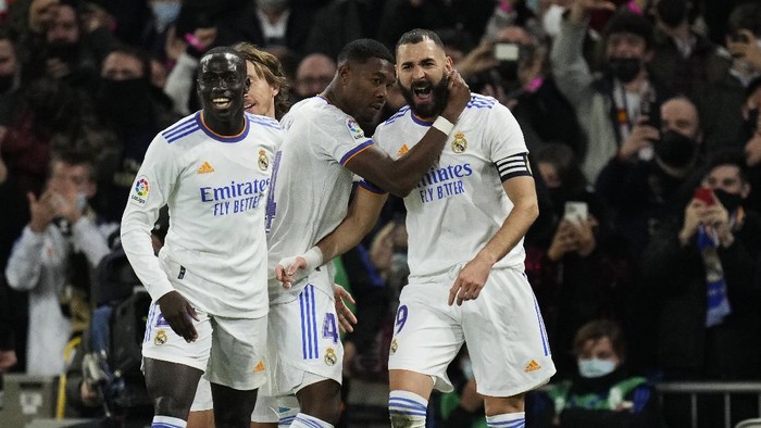 Real Madrids Karim Benzema, right, celebrates with teammates after scoring the opening goal during the Spanish La Liga soccer match between Real Madrid and Atletico Madrid at Santiago Bernabeu stadium in Madrid, Spain, Sunday, Dec. 12, 2021. (AP Photo/Bernat Armangue)