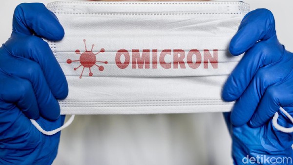 Female doctor holds a face mask with - Omicron variant text on it. Covid-19 new variant - Omicron. Omicron variant of coronavirus. SARS-CoV-2 variant of concern