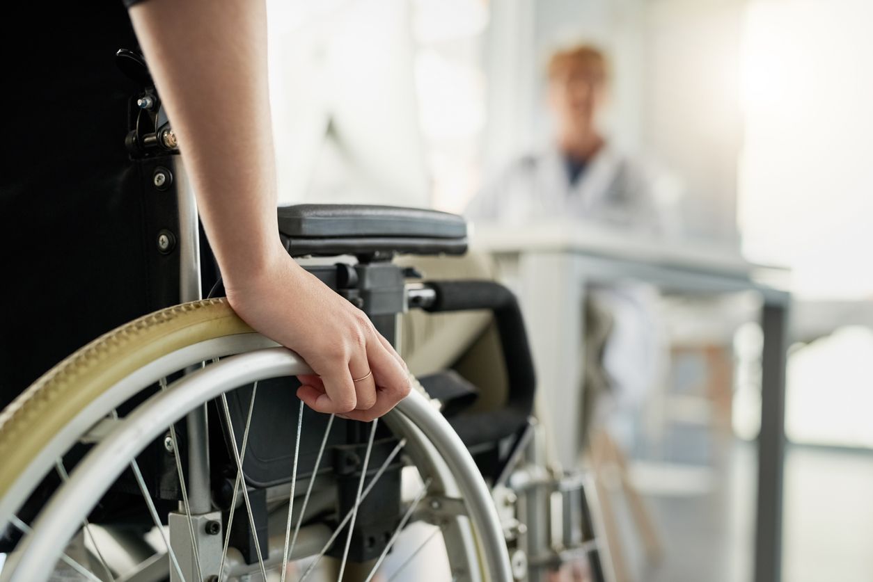 Cropped shot of an unrecognizable woman in a wheelchair visiting the doctor's rooms for a consultation