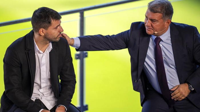 Barcelona striker Sergio Aguero is comforted by Barcelona president Joan Laporta during a press conference at the Camp Nou stadium in Barcelona, Spain, Wednesday, Dec. 15, 2021. Sergio Aguero has announced his retirement from football on Wednesday due to a heart condition. (AP Photo/Emilio Morenatti)