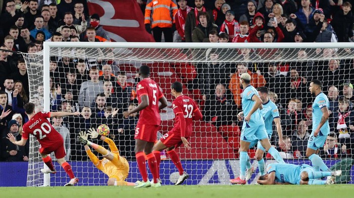 LIVERPOOL, ENGLAND - DECEMBER 16: Diogo Jota of Liverpool scores their sides first goal past Martin Dubravka of Newcastle United during the Premier League match between Liverpool and Newcastle United at Anfield on December 16, 2021 in Liverpool, England. (Photo by Clive Brunskill/Getty Images)