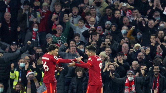 Liverpools Trent Alexander-Arnold, left, celebrates with Liverpools Roberto Firmino after scoring his sides third goal during the English Premier League soccer match between Liverpool and Newcastle United at Anfield stadium in Liverpool, England, Thursday, Dec. 16, 2021. (AP Photo/Jon Super)