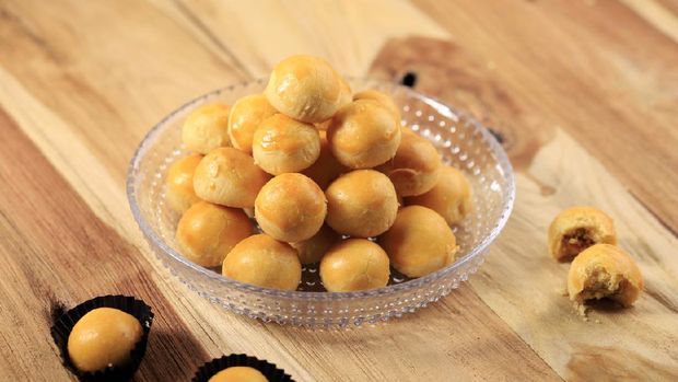 A Pile of Nastar or Ananas Taartjes or Pineapple Tart, Most Popular Various of Kue Kering Lebaran, Usually Served During Hari Raya. Wooden Background with Negative Space.