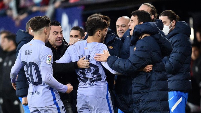 PAMPLONA, SPAIN - DECEMBER 12: Abde Ezzalzouli of FC Barcelona celebrates after scoring their sides second goal with Xavi, Head Coach of FC Barcelona and team mates during the La Liga Santander match between CA Osasuna and FC Barcelona at Estadio El Sadar on December 12, 2021 in Pamplona, Spain. (Photo by Juan Manuel Serrano Arce/Getty Images)
