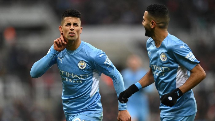 NEWCASTLE UPON TYNE, ENGLAND - DECEMBER 19: Joao Cancelo of Manchester City celebrates after scoring their sides second goal during the Premier League match between Newcastle United and Manchester City at St. James Park on December 19, 2021 in Newcastle upon Tyne, England. (Photo by Stu Forster/Getty Images)