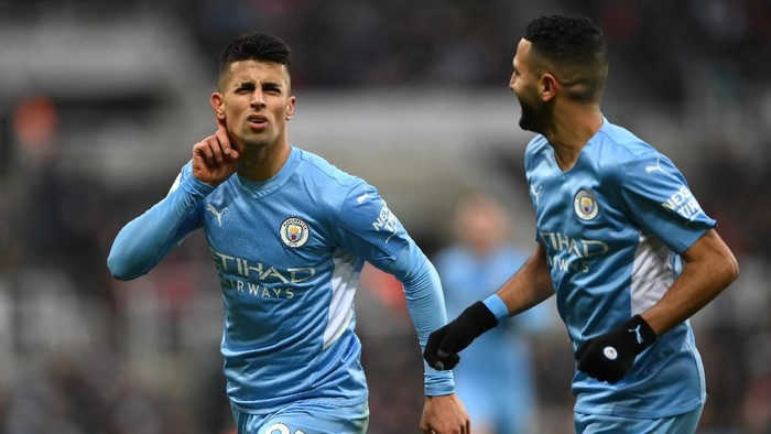 Manchester City NEWCASTLE UPON TYNE, ENGLAND - DECEMBER 19: Joao Cancelo of Manchester City celebrates after scoring their sides second goal during the Premier League match between Newcastle United and Manchester City at St. James Park on December 19, 2021 in Newcastle upon Tyne, England. (Photo by Stu Forster/Getty Images)