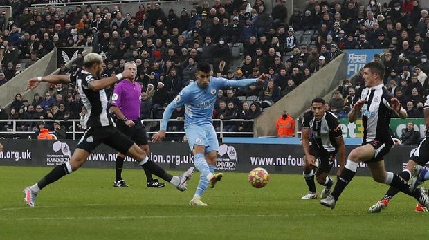 Soccer Football - Premier League - Newcastle United v Manchester City - St James' Park, Newcastle, Britain - December 19, 2021  Manchester City's Joao Cancelo scores their second goal Action Images via Reuters/Lee Smith EDITORIAL USE ONLY. No use with unauthorized audio, video, data, fixture lists, club/league logos or 'live' services. Online in-match use limited to 75 images, no video emulation. No use in betting, games or single club /league/player publications.  Please contact your account representative for further details.