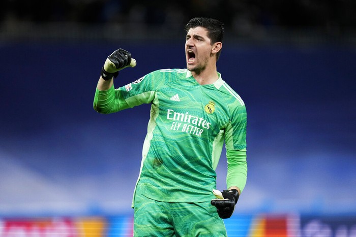 Real Madrids goalkeeper Thibaut Courtois celebrates after teammate Toni Kroos scored the opening goal during the Champions League group D soccer match between Real Madrid and Inter Milan at the Santiago Bernabeu stadium, in Madrid, Spain, Tuesday, Dec. 7, 2021. (AP Photo/Bernat Armangue)